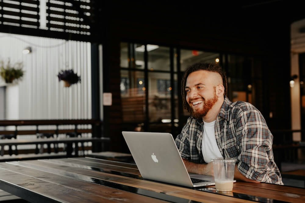 Business owner using a laptop to manage customer workflows and CRM operations